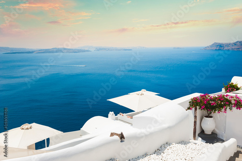 Beautiful sunset at Santorini island, Greece. White architecture on the rocks with sea view. Famous travel destination