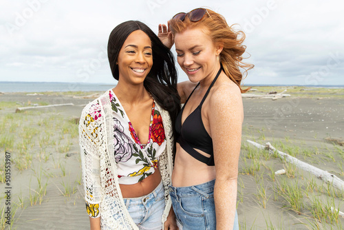 Two woman at ocean beach together.