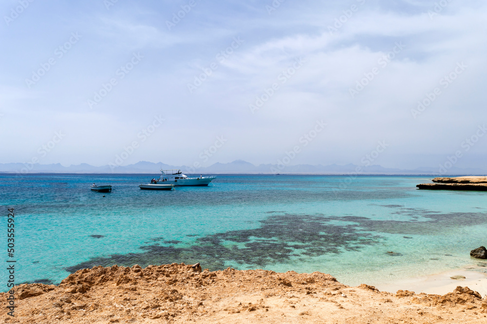 Paradise beach coastline. Beauty of Egypt nature. Red Sea seascape with corals and boats.