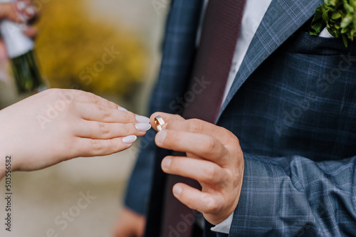 Hands with gold rings of the bride and groom close-up at the wedding ceremony. Wedding photography  portrait  concept.