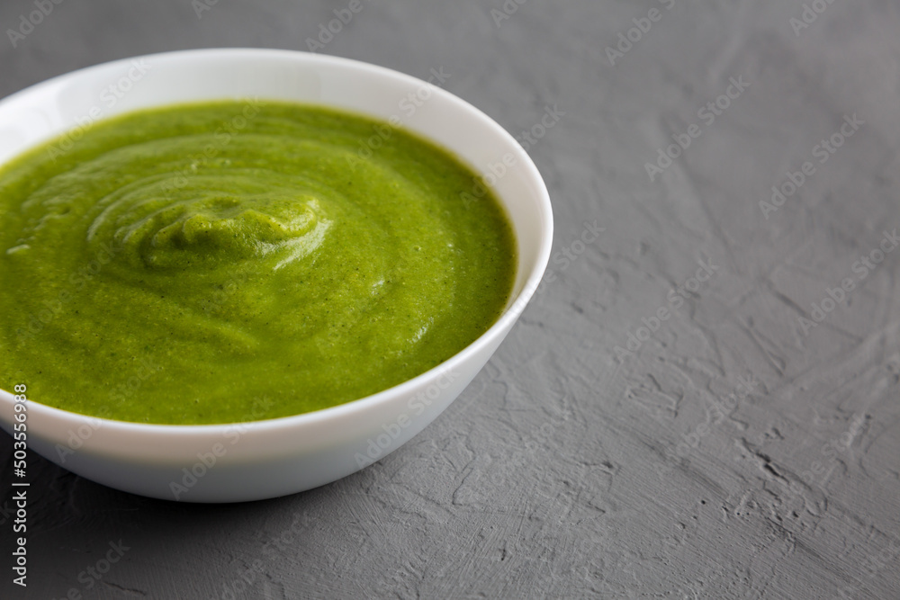 Homemade Organic Broccoli Soup on gray background, side view. Copy space. Homemade Organic Broccoli Soup on gray background, side view. Copy space.