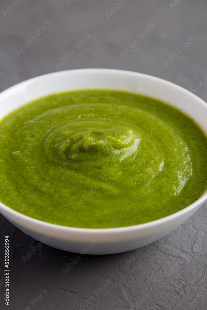 Homemade Organic Broccoli Soup on gray background, side view. Homemade Organic Broccoli Soup on gray background, side view.