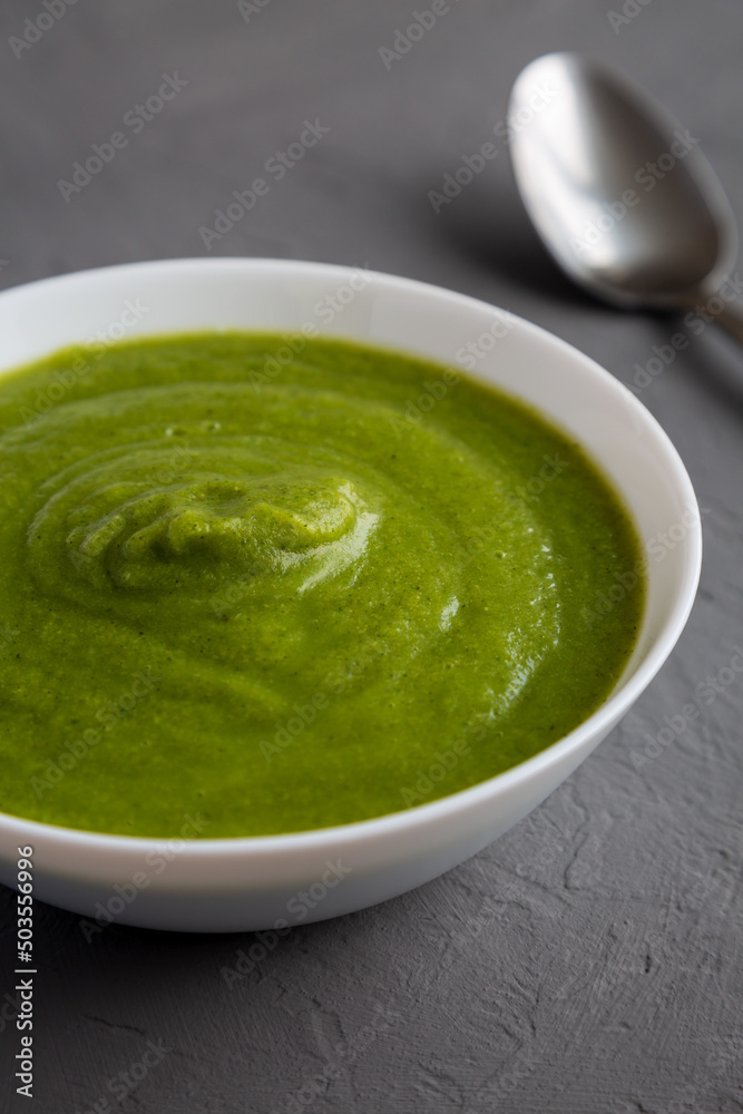 Homemade Organic Broccoli Soup on gray background, side view. Close-up. Homemade Organic Broccoli Soup on gray background, side view. Close-up.