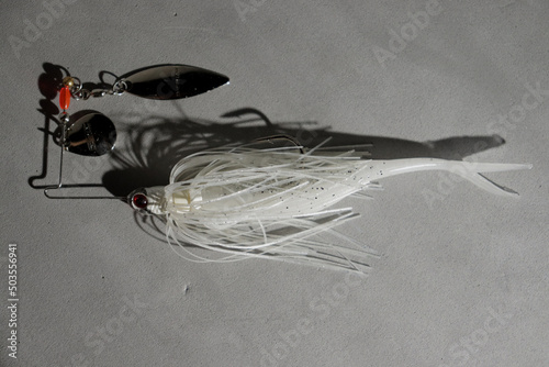 Top view of a spinnerbait on a gray surface photo