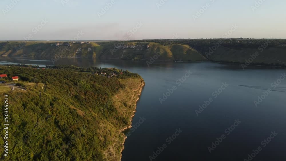 Aerial view of wide Dnister river and distant rocky hills in Bakota area, part of the National park, Podilski Tovtry, in Ukraine. 4k. High quality 4k footage. Aerial view of wide Dnister river and distant rocky hills in Bakota area, part of the National park, Podilski Tovtry, in Ukraine. 4k. High quality 4k footage.