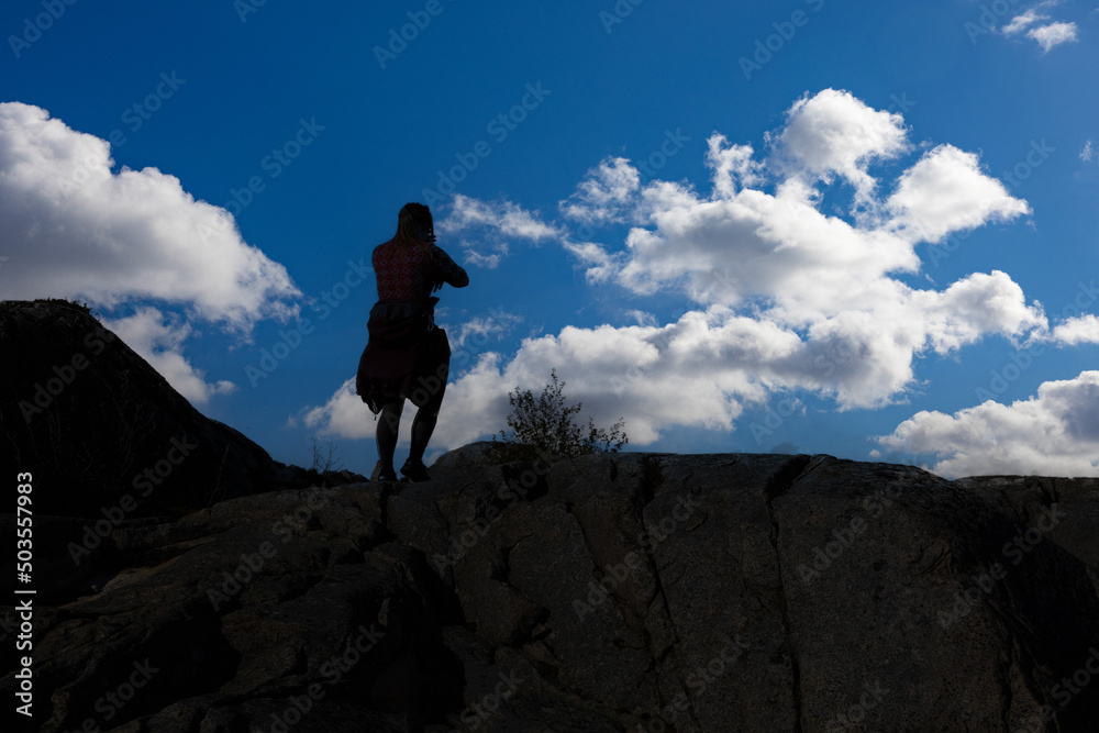 Happy girl hike to Vikerheia mountain a great summer day in silhouette ,Northern Norway,scandinavia,Europe
