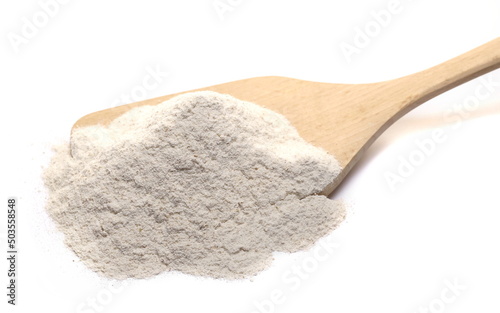 Buckwheat flour in wooden spoon  isolated on white  