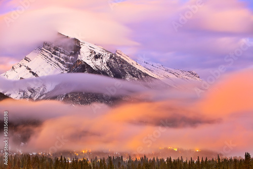 Mount Rundle and Banff Townsite at dusk, motion blurred clouds, Banff National Park, Alberta, Canada. photo