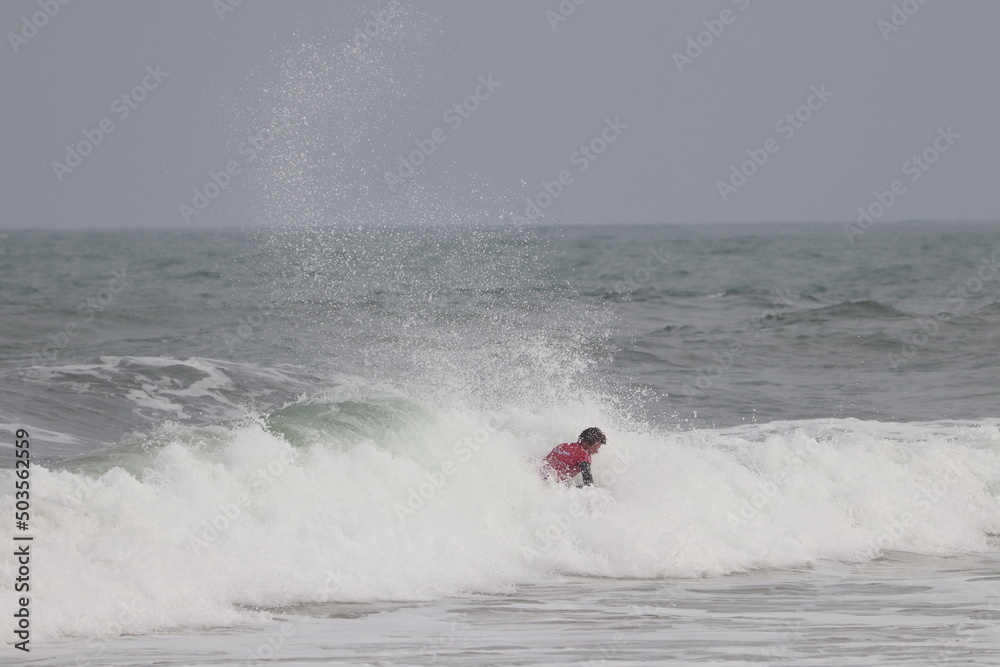 Biarritz coast beach with lighthouse and surfers Biarritz coast beach with lighthouse and surfers