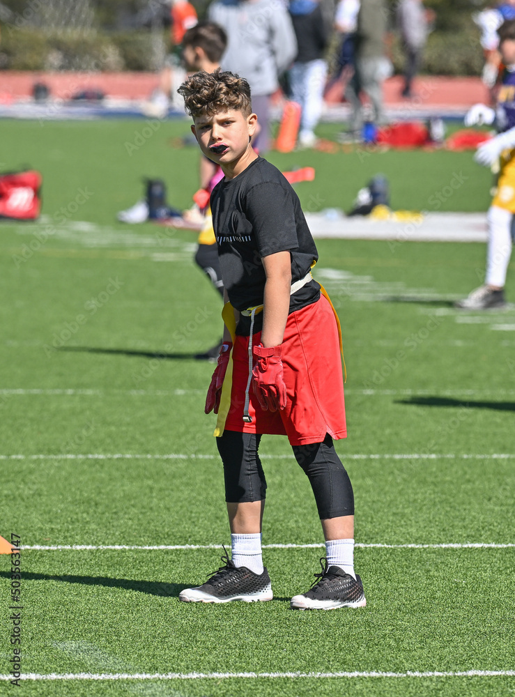 Young athletic boy catching, running and throwing the ball in a football game Young athletic boy catching, running and throwing the ball in a football game