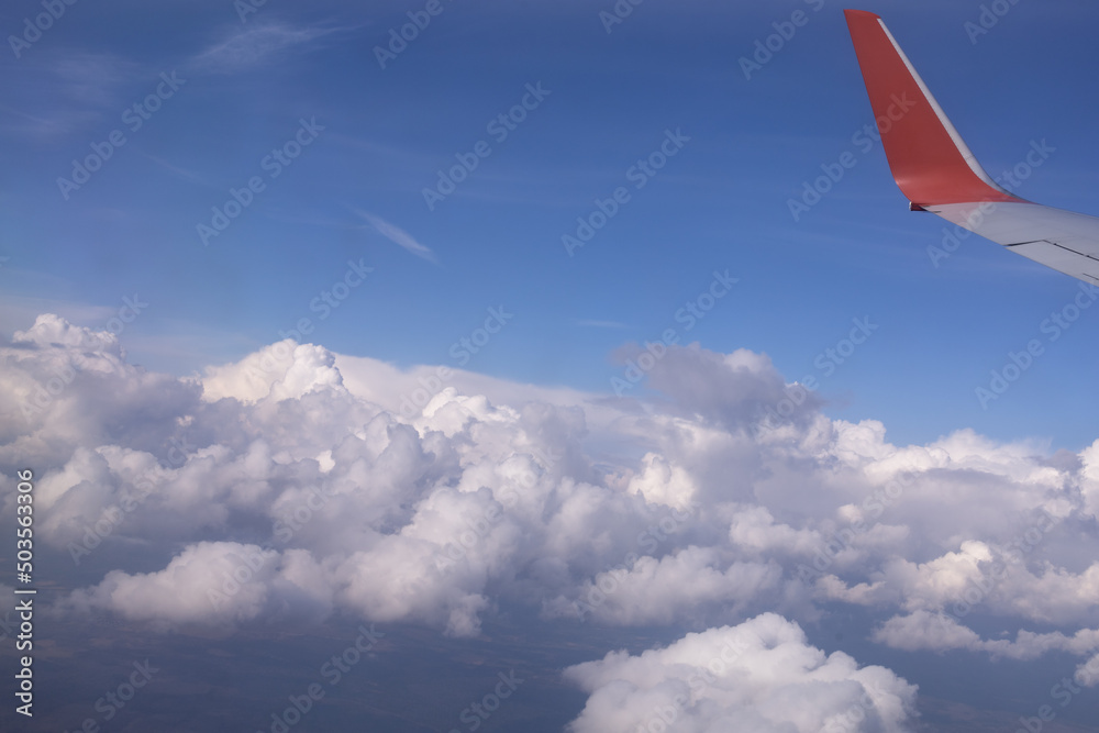 the wing of a flying aircraft against the background of clouds the wing of a flying aircraft against the background of clouds
