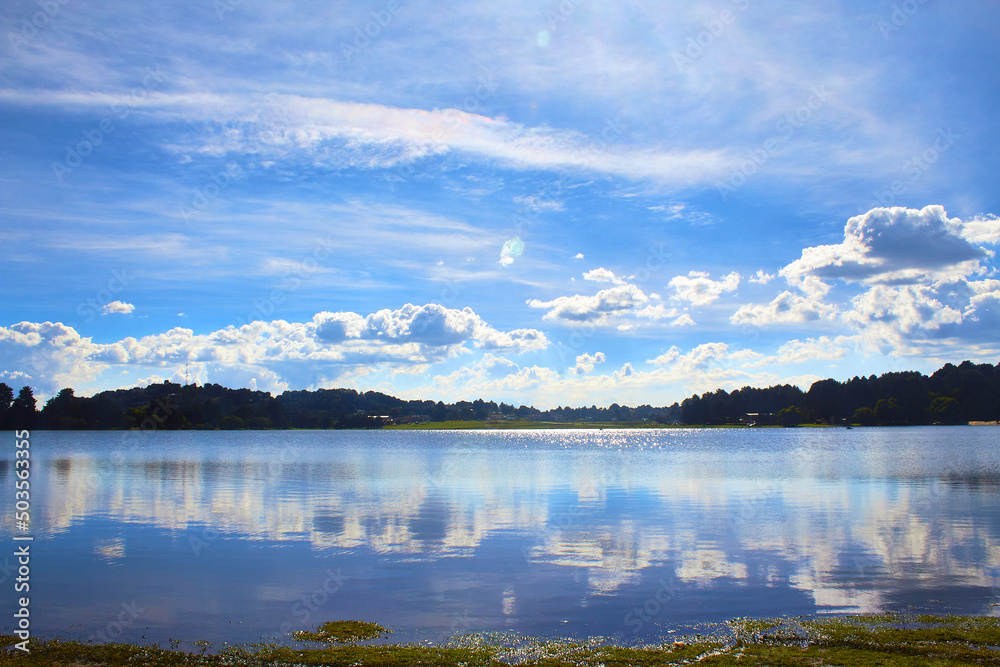 blue lake beautiful at sunny day with some clouds in the blue sky with reflection like a mirror in the oro of hidalgo state of mexico