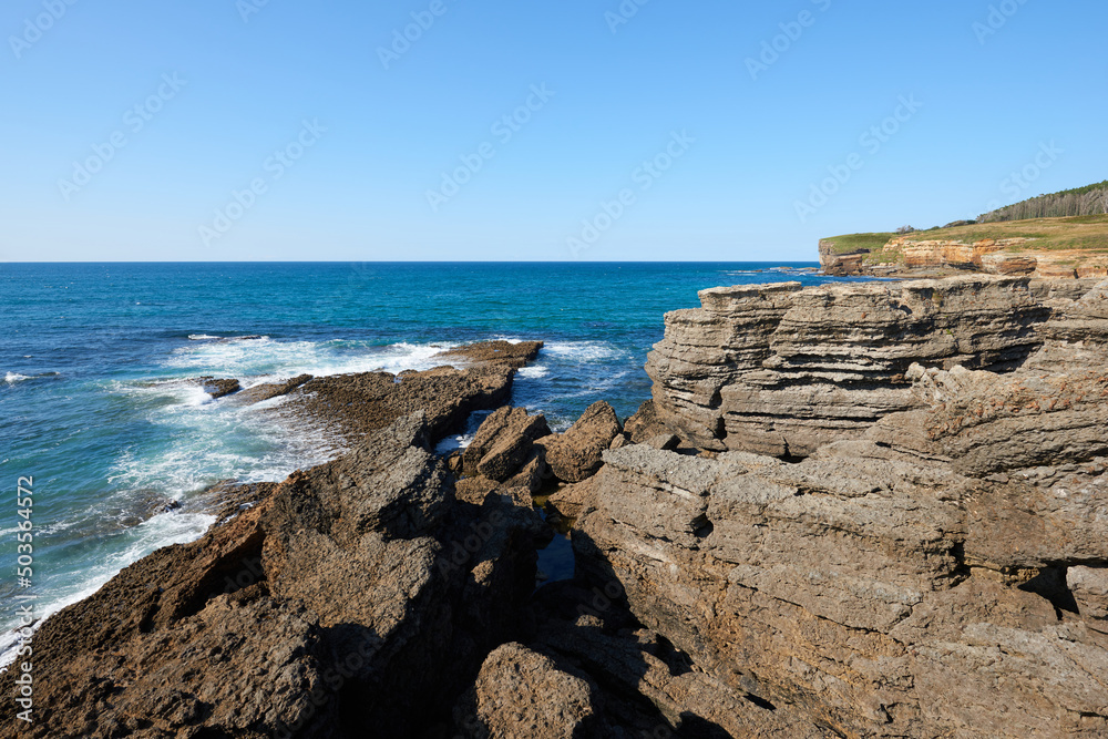 Cliffs with deep blue sea and clear skies Cliffs with deep blue sea and clear skies