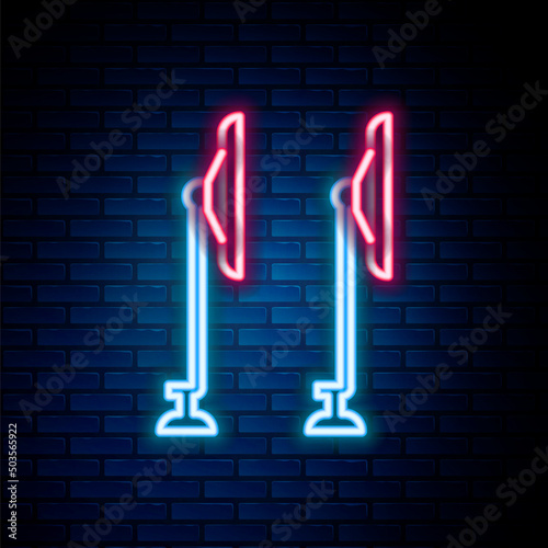 Glowing neon line Windscreen wiper icon isolated on brick wall background. Colorful outline concept. Vector