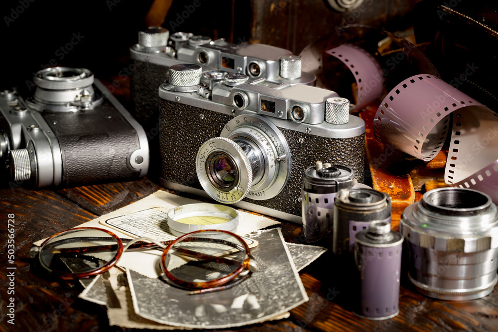 Old vintage photo cameras on an old background.