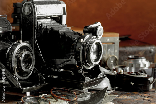 Old vintage photo cameras on an old background.