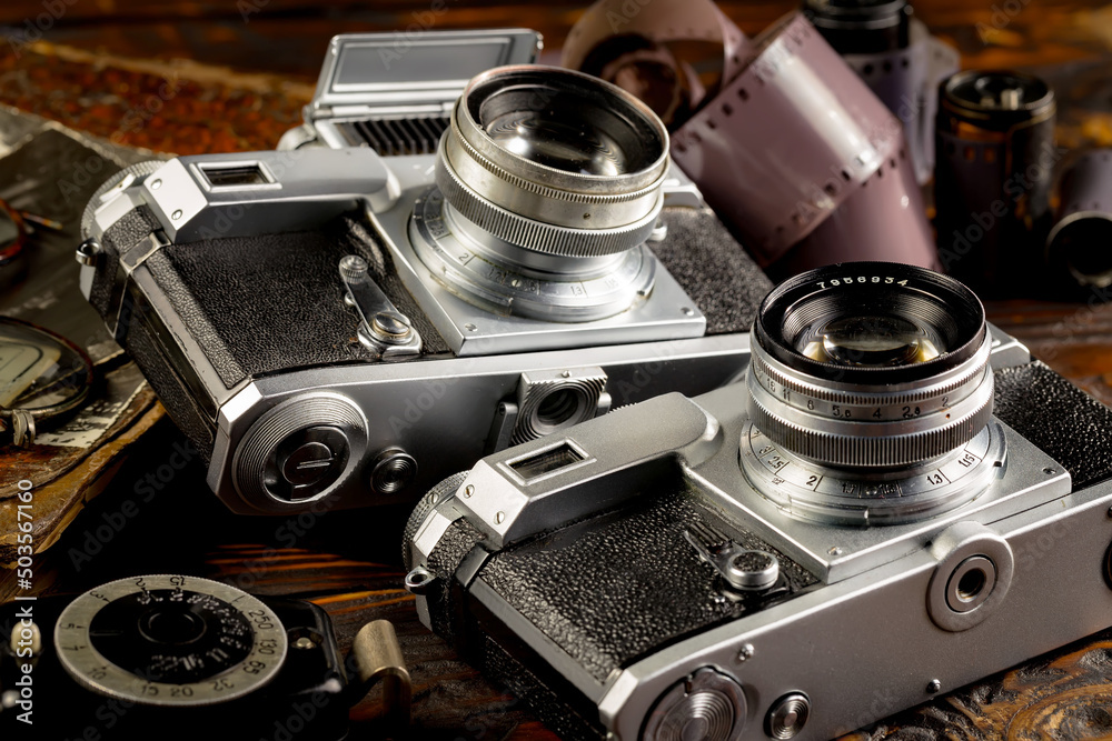 Old vintage photo cameras on an old background.