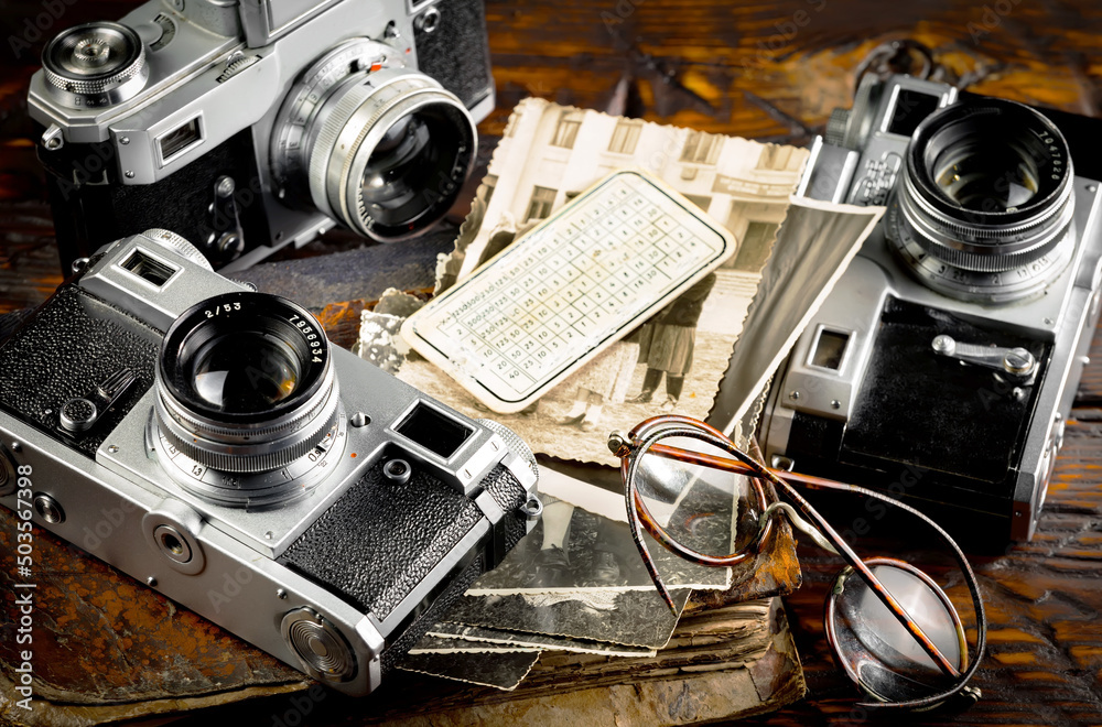 Old vintage cameras on an old background.