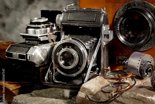 Old camera in the studio on an old background