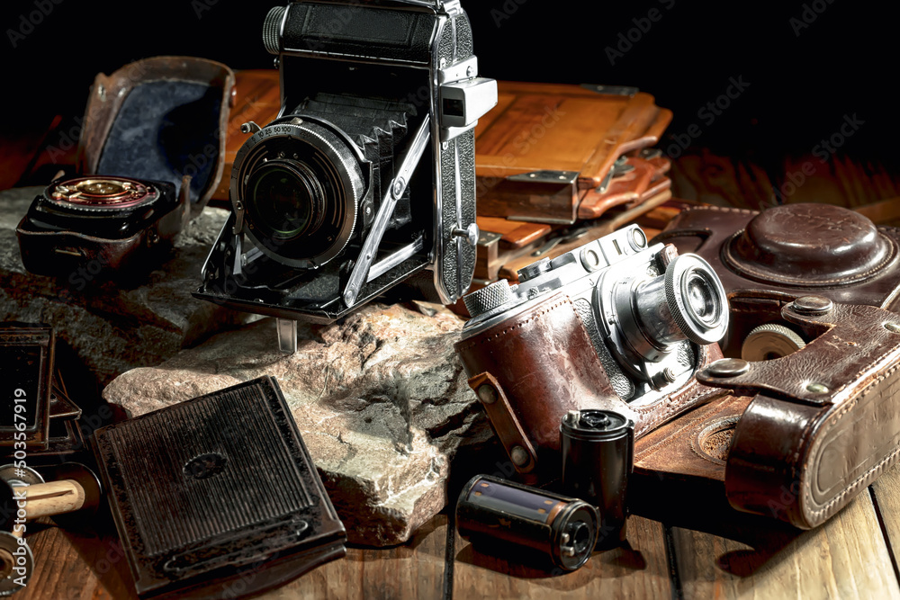 An old camera in a composition on an old background, on a table