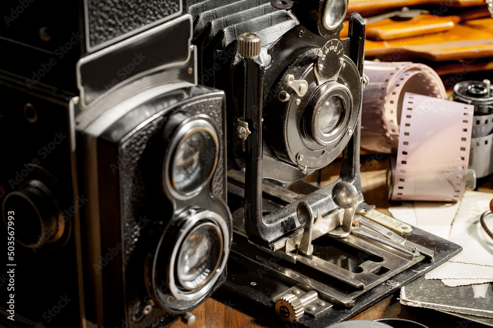 Old camera in the studio on an old background Old camera in the studio on an old background