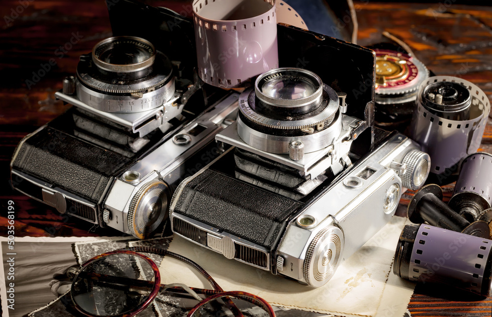 Old vintage photo cameras on an old background.