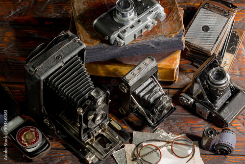Old vintage cameras on an old background. © vizafoto