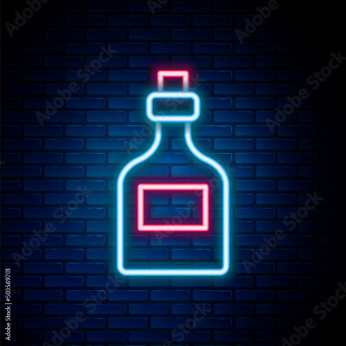 Glowing neon line Alcohol drink Rum bottle icon isolated on brick wall background. Colorful outline concept. Vector