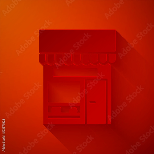 Paper cut Shopping building or market store icon isolated on red background. Shop construction. Paper art style. Vector Illustration