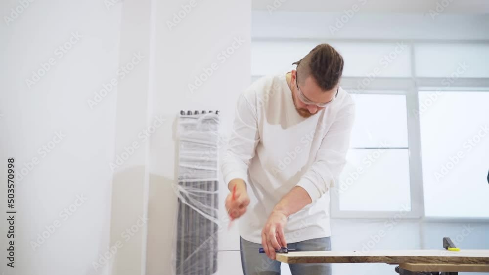 carpenter makes measurements and draws on wood carpenter makes measurements and draws on wood