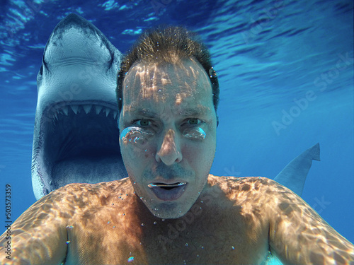 Photography Man taking a selfie underwater with a shark in the background