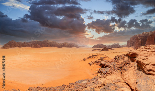 Red sands  mountains  dramatic sky and marthian landscape panorama of Wadi Rum desert  Jordan