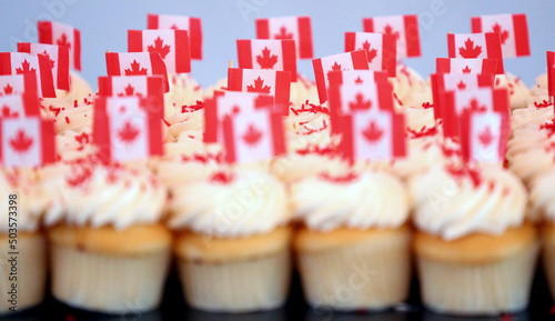 Canada flags decorate cupcakes with icing to celebrate Canada Day.  photo