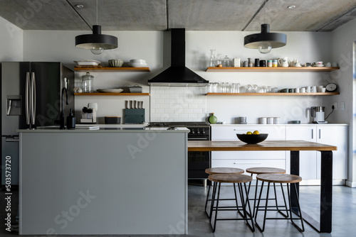 Interior of modern kitchen with appliances, utensils and kitchen island photo