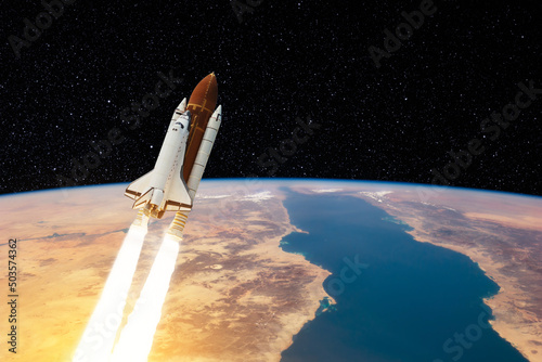 Fototapeta Naklejka Na Ścianę i Meble -  Spaceship lift off. Space shuttle with smoke and blast takes off into the starry sky. Rocket starts into space. Concept. Elements of this image furnished by NASA.