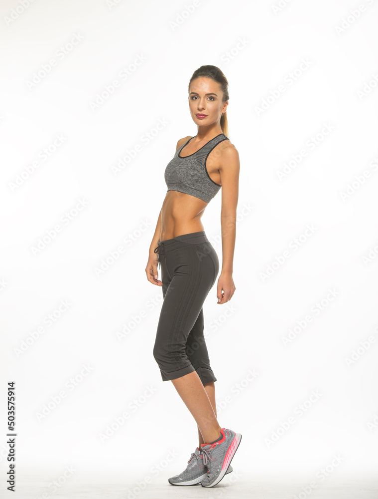 athletic girl in training clothes posing on a white background in the studio in full growth
athletic girl in training clothes posing on a white background in the studio in full growth
