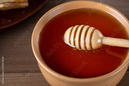 Using wooden spoon for honey in bowl