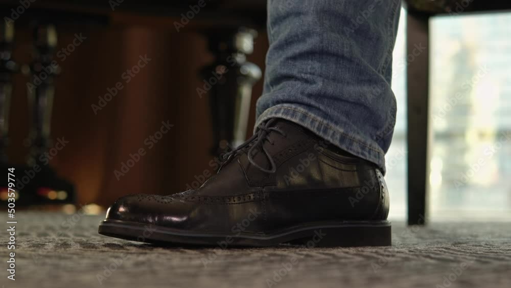 the foot beats a rhythm on the floor. The musician taps the melody. Men's leather shoe. Ultra HD the foot beats a rhythm on the floor. The musician taps the melody. Men's leather shoe. Ultra HD