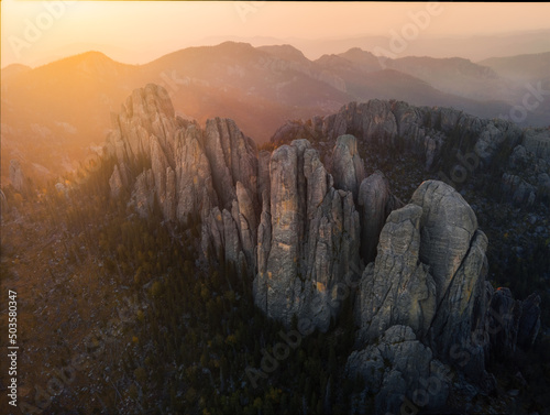 misty sunrise over the mountains of custer state park in the needles of south dakota © Mitch