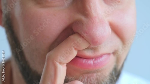 Adult Caucasian Male Picking Nose with Index Finger photo