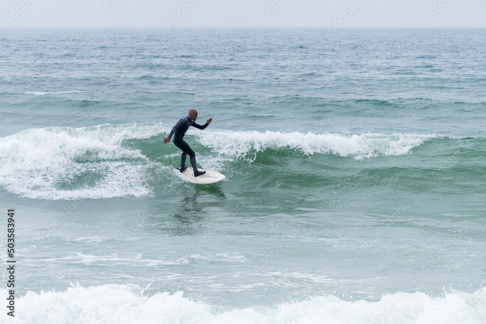 Surfer riding waves