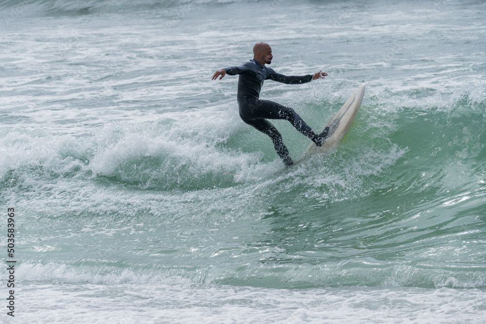 Surfer riding waves