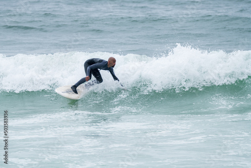 Surfer riding waves © homydesign