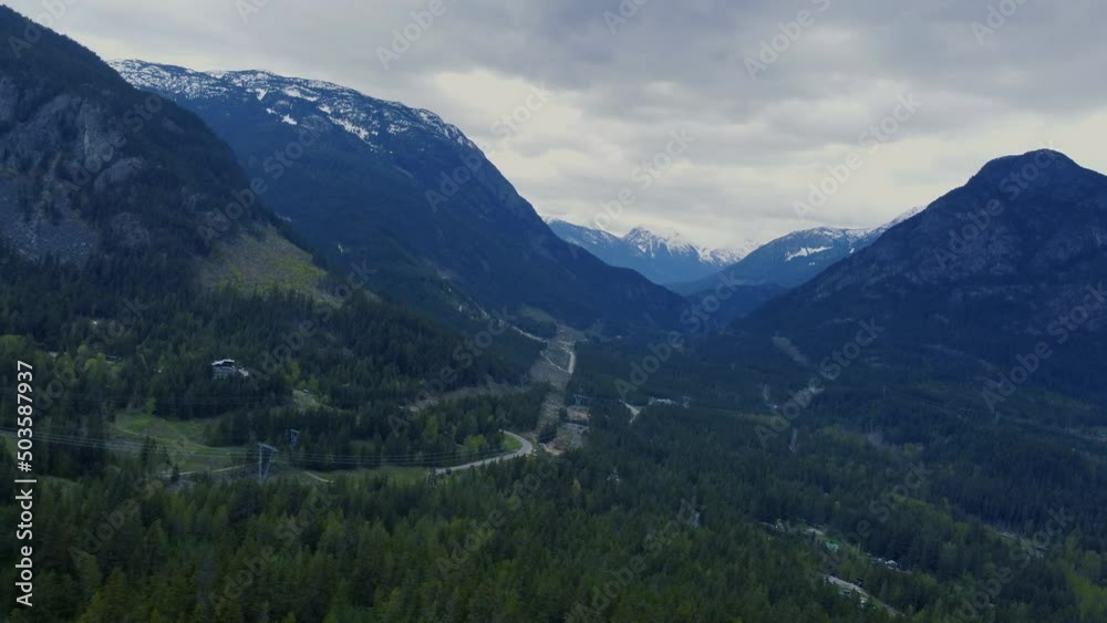 Fly over cliffs near the hills with coniferous forests in cloud weather Fly over cliffs near the hills with coniferous forests in cloud weather