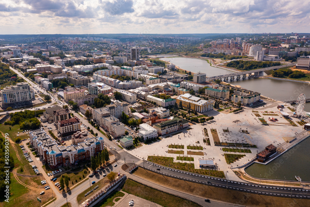 View from drone of modern districts of Cheboksary and large landscaped Red Square in city center on shore of artificial bay on sunny summer day, Chuvashia, Russia.