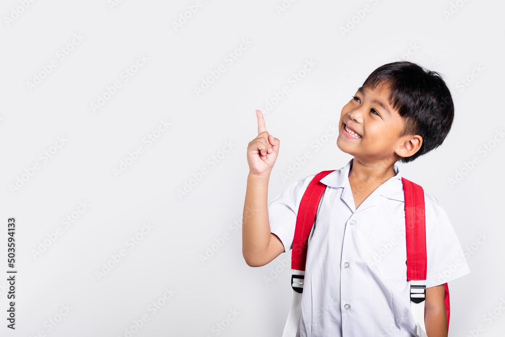 Asian toddler smiling happy wear student thai uniform red pants keeps pointing finger at copy space in studio shot isolated on white background, Portrait little children boy preschool, Back to school Asian toddler smiling happy wear student thai uniform red pants keeps pointing finger at copy space in studio shot isolated on white background, Portrait little children boy preschool, Back to school
