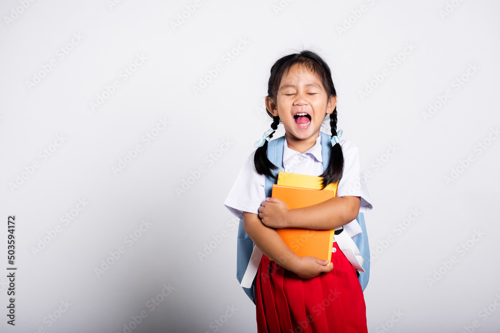 Asian adorable toddler smiling happy wear student thai uniform red skirt stand hold or hugging book in studio shot isolated on white background, Portrait little children girl preschool, Back to school Asian adorable toddler smiling happy wear student thai uniform red skirt stand hold or hugging book in studio shot isolated on white background, Portrait little children girl preschool, Back to school