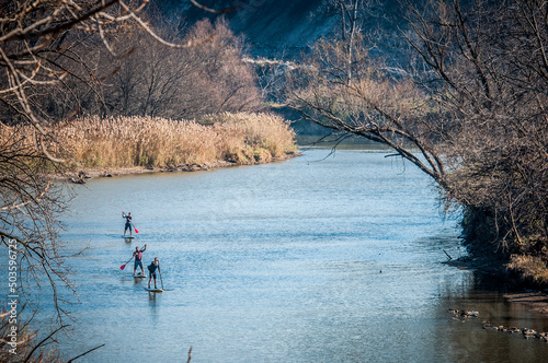 Stand up paddle boarding down river photo