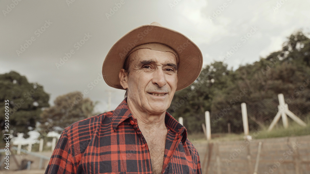 Latin farmer man in the casual shirt in the farm on the farm background. Latin farmer man in the casual shirt in the farm on the farm background.