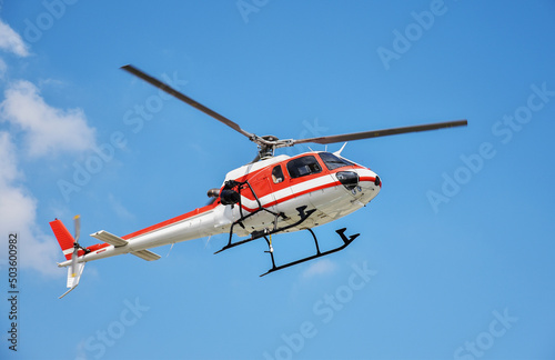 Helicopter with camera mounted on blue sky
